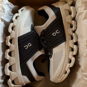 On Running Cream and Black Athletic Shoes